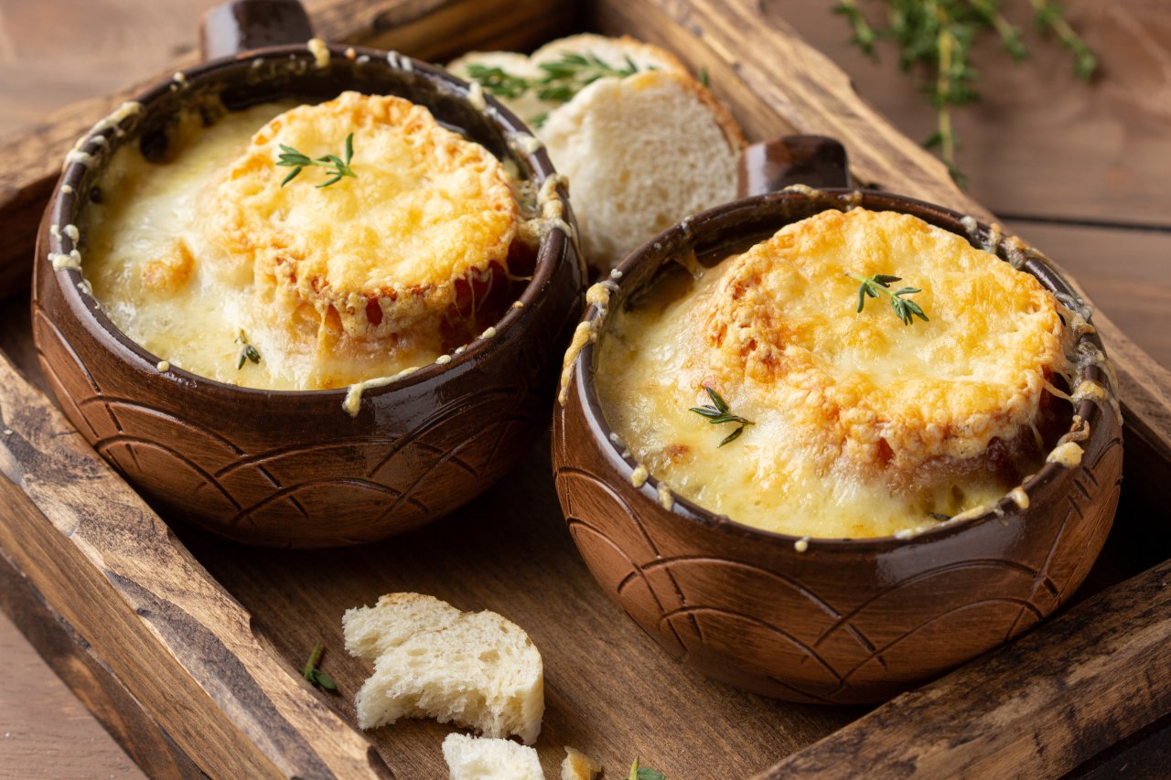 Onion soup or croutons with gratin, Gruyère cheese and thyme, a delicious warm meal in autumn